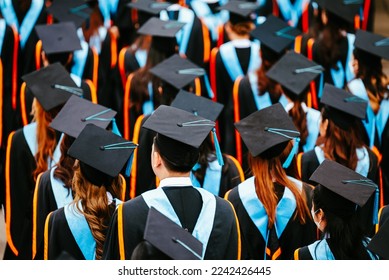 Congratulated the graduates in University  Rear view of the university graduates in graduation gowns and caps - Shutterstock ID 2242426445