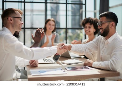 Congratulating the new partners in modern office - Shutterstock ID 2208314411