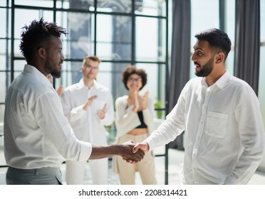 Congratulating the new partners in modern office - Shutterstock ID 2208314421
