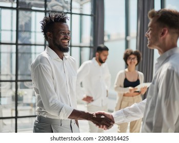 Congratulating the new partners in modern office - Shutterstock ID 2208314425