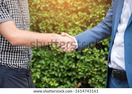 Congratulation to collaboration partner after sign on contract. Diverse Businessman shake hands together with businessman to introduce meeting. Trustworthy student friends meeting. Business Concept