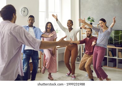 Congratulations: Diverse Group Of Excited Young People Meet Man Who's Achieved Great Success. Long Time No See: Happy, Emotional Friends Spread Arms Wide Open To Hug Friend Who's Finally Back Home