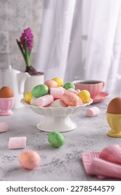 Congratulatory Easter composition: colorful Easter eggs and hyacinths on a light gray table. Happy Easter and spring holiday concept.