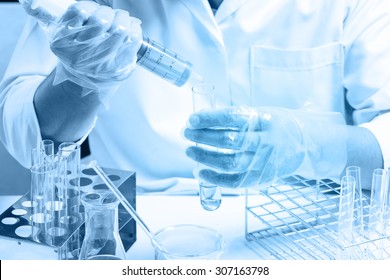 Conical Flask In Scientist Hand With Lab Glassware Background, Laboratory Research Concept