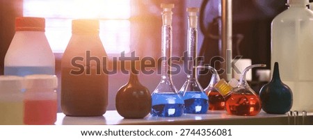 Conical flasks and test tubes with acid in chemical laboratory. Reagents acid suspensions for experiments, close-up of flask with samples of acids. Chemical industry concept. Copy ad text space