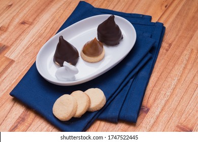 Conitos Dulce De Leche With Chocolate Sweet Cones On Rabbit White Plate On Blue Kitchen Rag Pan Over Wood