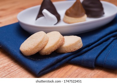 Conitos Dulce De Leche With Chocolate Sweet Cones On Rabbit White Plate On Blue Kitchen Rag Pan Over Wood