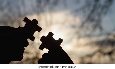 Connect the appropriate puzzles into a whole, silhouettes against the sky. - Shutterstock ID 1984881164
