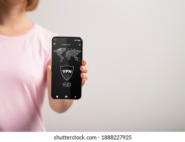 Connect to VPN. Closeup of unrecognizable woman holding and showing smartphone with virtual private network application connected to local network over the internet. Information and location security
