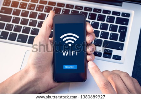 Connect to WiFi wireless internet network with smartphone at coffee shop or hotel with button on mobile device screen, free public hotspot secure access to web for email and website browsing