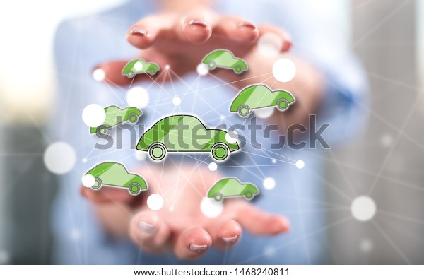 Connected car concept between hands of a woman
in background