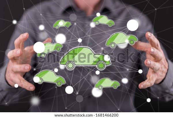 Connected car concept between hands of a man\
in background