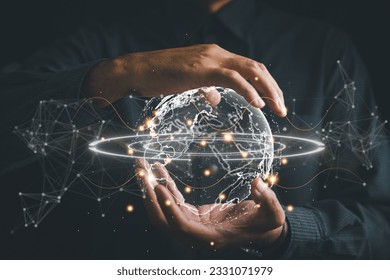 Connected in Digital Era, Businessman hand holds globe, illustrating interconnectedness facilitated by technology. Big data analytics and business intelligence revolutionize global decision processes.