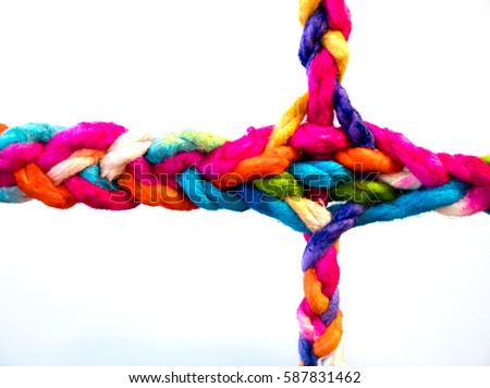Connected group concept as many different ropes tied and linked together as an unbreakable chain as a community trust and faith metaphor and learning