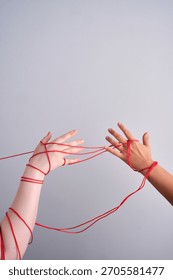 Connected hands creating red string relationship