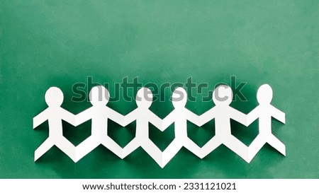 Connected paper doll in green background _ wide
