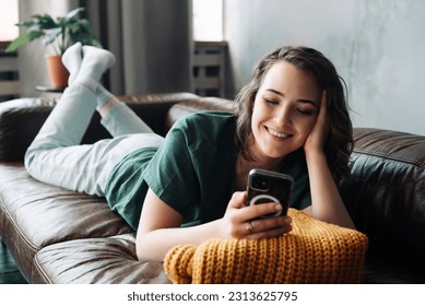 Connected and Productive: Young Woman Engaging with Smartphone at Home, Student Girl Embracing Mobile Communication and Technology in her Room, Balancing Work, Study, and Digital Lifestyle - Powered by Shutterstock