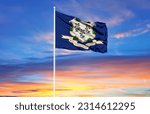 Connecticut flag on flagpoles and blue sky