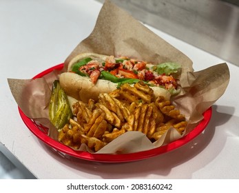 A Connecticut Style Lobster Roll With Fries