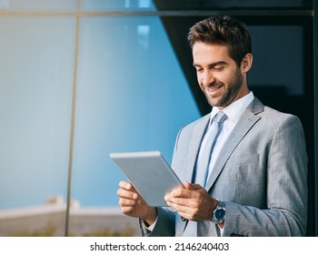 Connecting to the city. Shot of a handsome young businessman using a digital tablet outside an office building. - Powered by Shutterstock