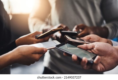 Connecting With A Fitness Buddy Theres An App For That. Shot Of A Group Of Unrecognizable People Using Their Mobile Phones Together In The Gym.