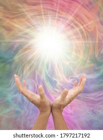 Connecting to Higher Dimensional Power for Inspiration - female open hands reaching up to a bright white light against a multicoloured vortex energy field with copy space 
