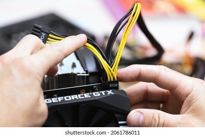 Connecting Power Supply To Video Card By PCI-E 8 Pin Cable. Close Up Of Person Installing Computer Graphic Card On Professional Computer. Russia, 17.08.2021