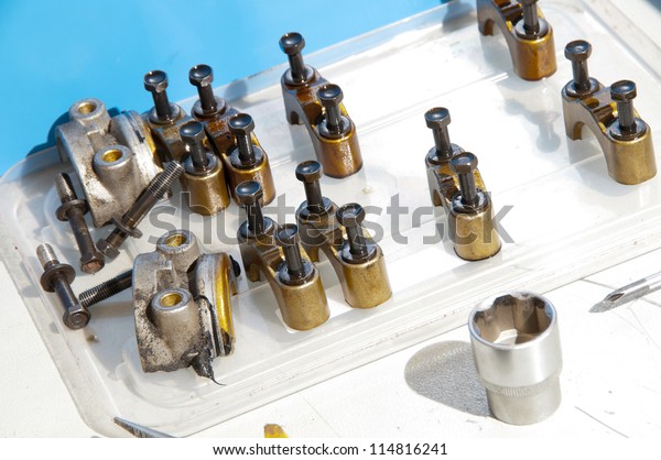 Connecting rods\
bottom heads on a workshop\
table