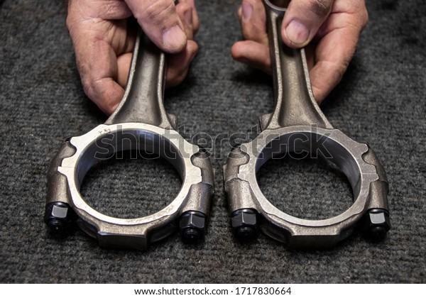 Connecting Rods in\
the hands. Parts of truck.\
