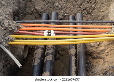 connecting underground cable infrastructure improvement installation. Construction site with A lot of communication Cables protected in tubes. high speed Internet Network cables are buried  - Shutterstock ID 2221657637
