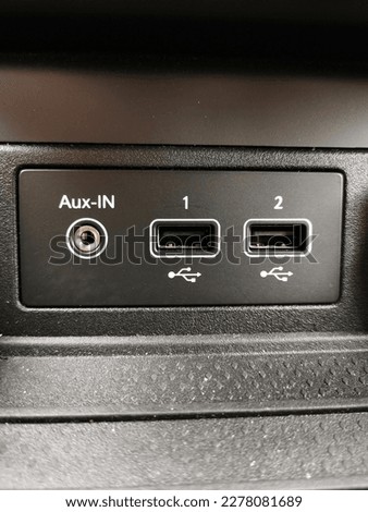 Connection for aux-in jack cable and two USB ports.