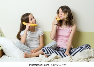 Connection, Communication Between People, Girls Play Phone, Talk With Each Other Through A Banana Pipe.