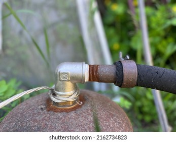 Connection Of The Pressure Vessel, Or Cylinder, And Rusty Steel Pipe Via Elbow Bend. A Knee Bend Is Used To Joint Any Kind Of Metal Pipes And Fittings