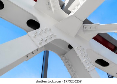 Connection Of Steel Powerful Straight Crossbar, Bridge Connection. View From Below On New Ceiling; Pillars With Steel Joints Are Painted In White. Bolt And Nut For Steel Jont Structure In Construction