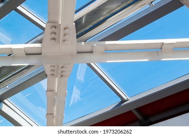 Connection Of Steel Powerful Straight Crossbar, Bridge Connection. View From Below On New Ceiling; Pillars With Steel Joints Are Painted In White. Bolt And Nut For Steel Jont Structure In Construction