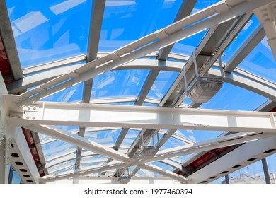 Connection Of Steel Powerful Straight Crossbar, Bridge Connection. View From Below On New Ceiling; Pillars With Steel Joints Are Painted In White. Bolt And Nut For Steel Jont Structure In Construction