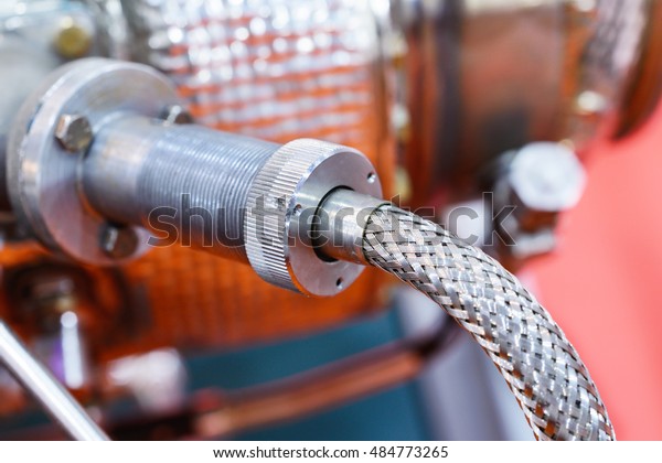 Connections hoses of a machinery\
industrial detail. Industrial background, closeup\
photo.