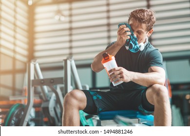 Conquer Your Body. Muscular Young Man Having A Rest In Gym. Copy Space On The Left Side