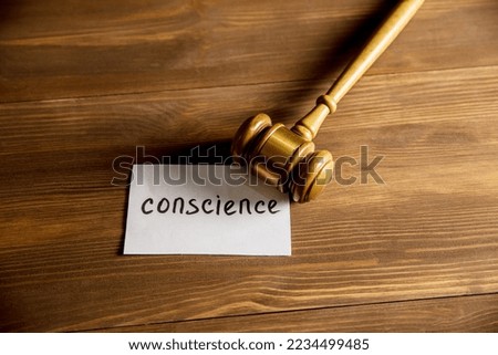 Conscience and judge's gavel on the table