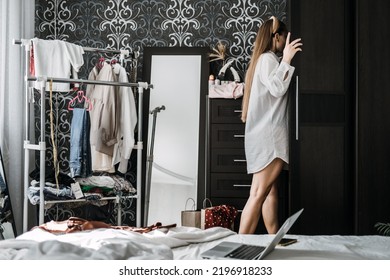 Conscious And Sustainable Closet. How To Declutter Clothes In Closet. Decluttering Wardrobe. Young Woman Decluttering