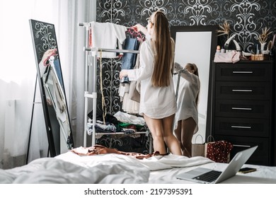 Conscious And Sustainable Closet. How To Declutter Clothes In Closet. Decluttering Wardrobe. Young Woman Decluttering