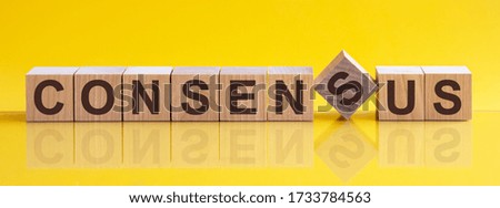 CONSENSUS word made with building blocks on the bright yellow background.