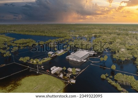Consequences of natural disaster. Flooded industrial business warehouse by hurricane Ian rainfall in Florida rural area