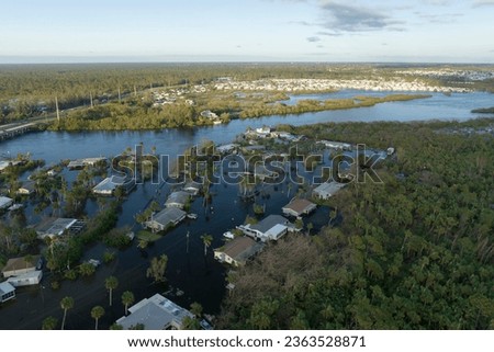 Consequences of natural disaster. Heavy flood with high water surrounding residential houses after hurricane rainfall in Florida residential area