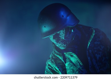 Consequences of nuclear war. Zombie apocalypse. Portrait of a scary zombie soldier in an ominous green light. Copy space. 