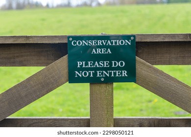 Conservation area, please do not enter sign on a wooden gate. - Shutterstock ID 2298050121