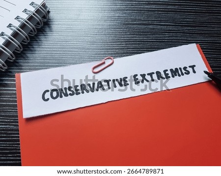 Conservative extremist writting on table background.