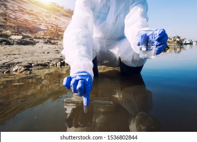 Conserve water and environment. Shot of an unrecognizable ecologist taking samples of water with test tube from city river to determine level of contamination and pollution. - Shutterstock ID 1536802844