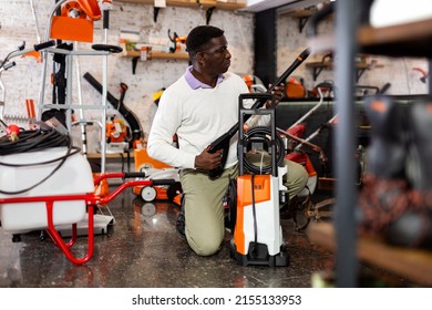 Considerate Customer Chooses Washer At A Garden Tool Shop