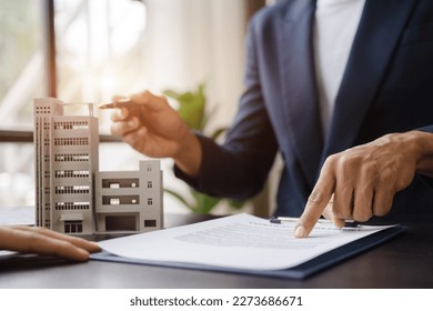 Considering buying a home, investing in real estate. Broker signs a sales agreement. agent, lease agreement, successful deal. - Shutterstock ID 2273686671